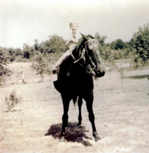Sue, age 5 or 6, astride Dan the plow horse